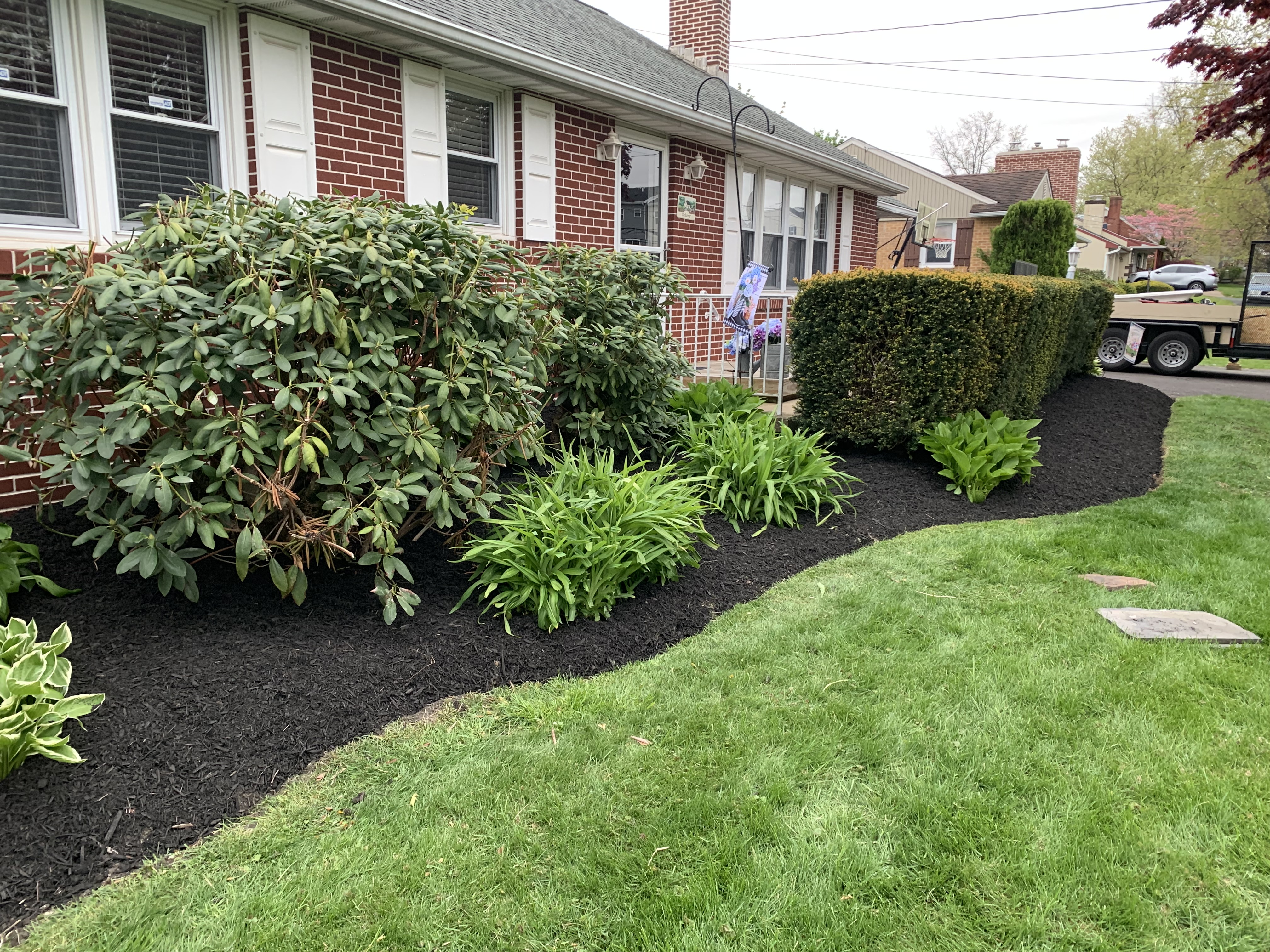 Front bed with mature plantings and precision-trimmed boxwood