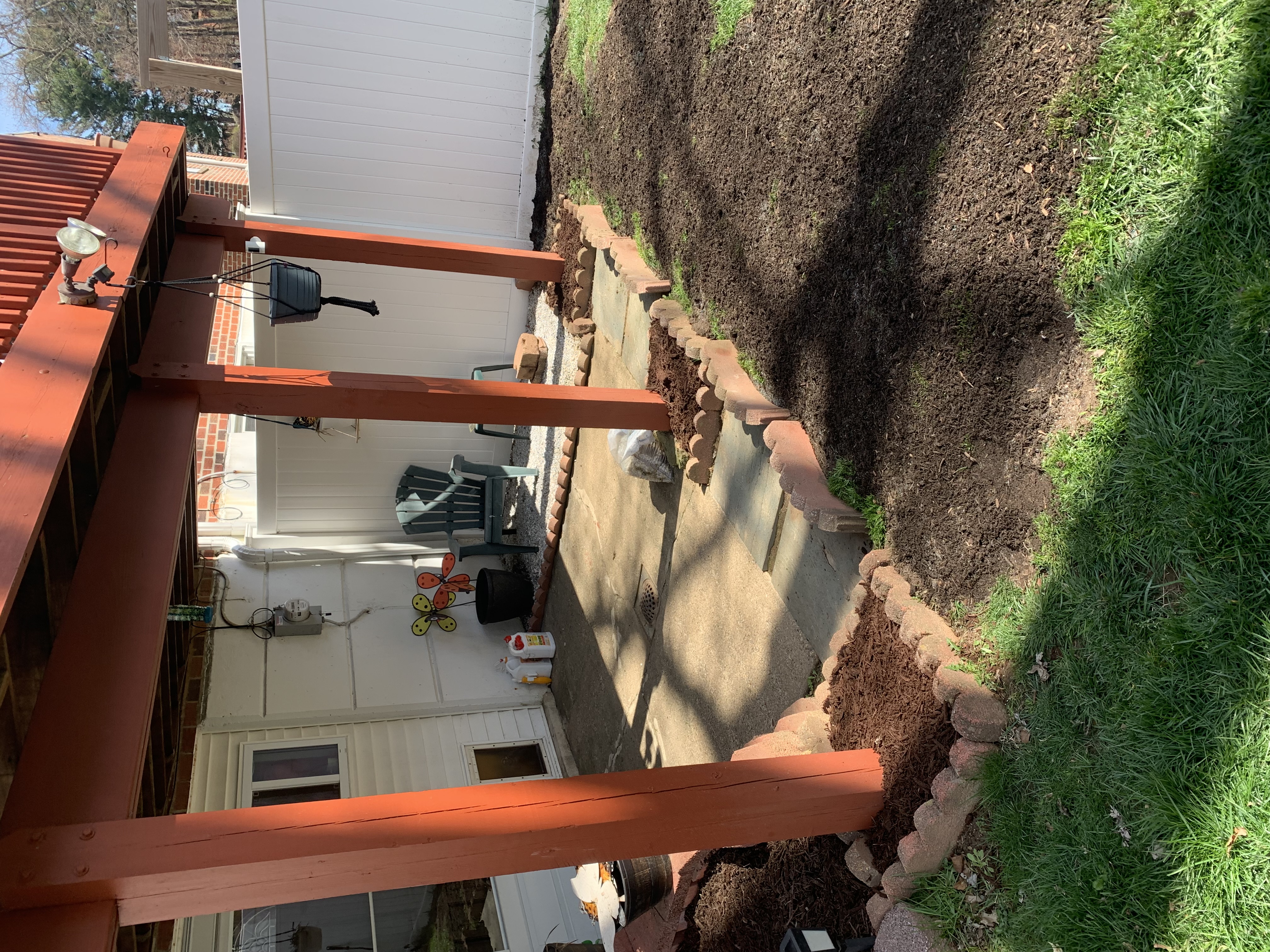 Patio area with new mulch bed and stone retaining border